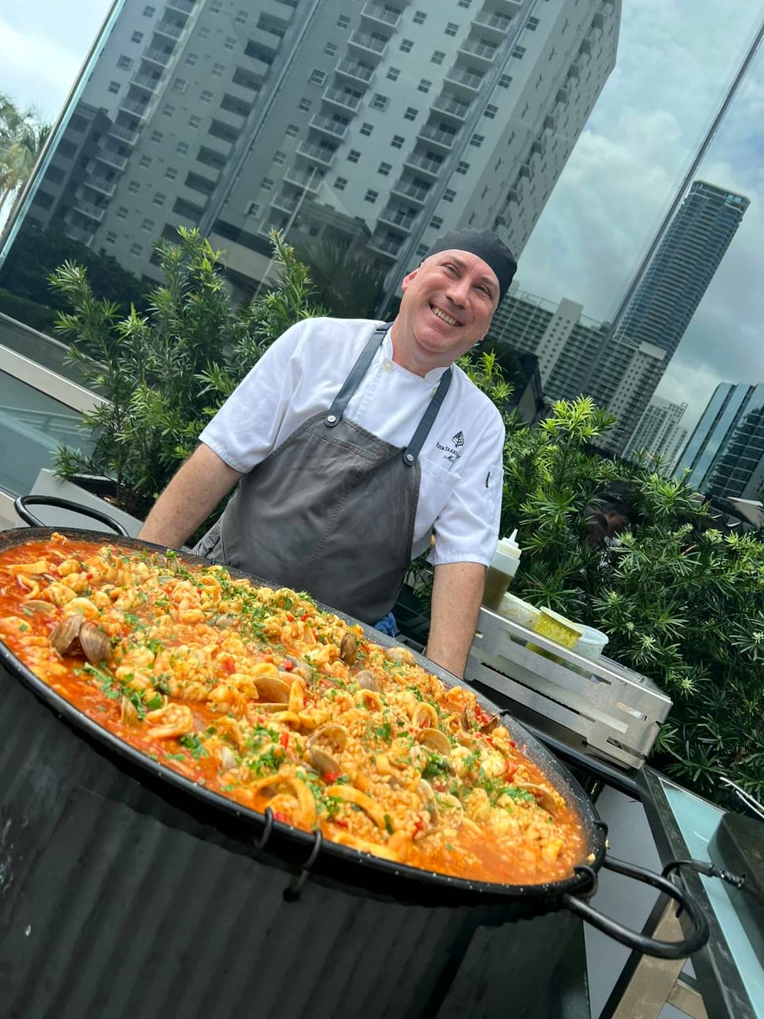 Chef Carlos Carone with a fresh seafood paella at a Central Florida event